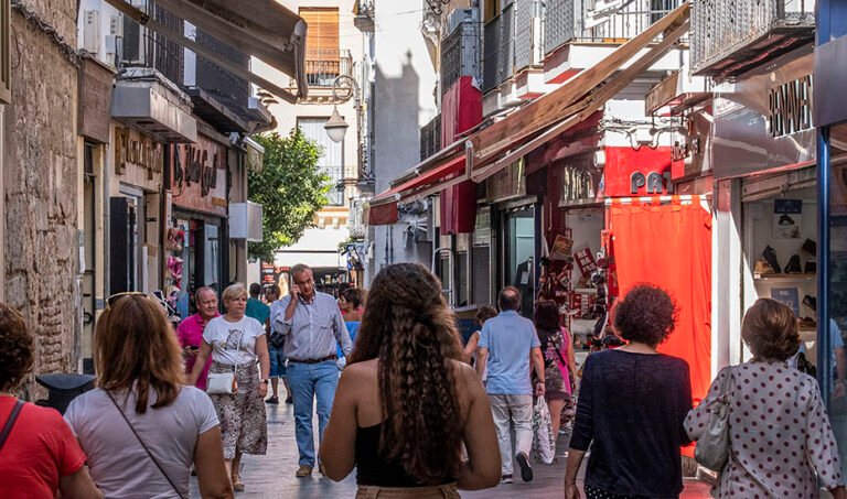 Ciudadanos caminan por el centro de Sevilla.